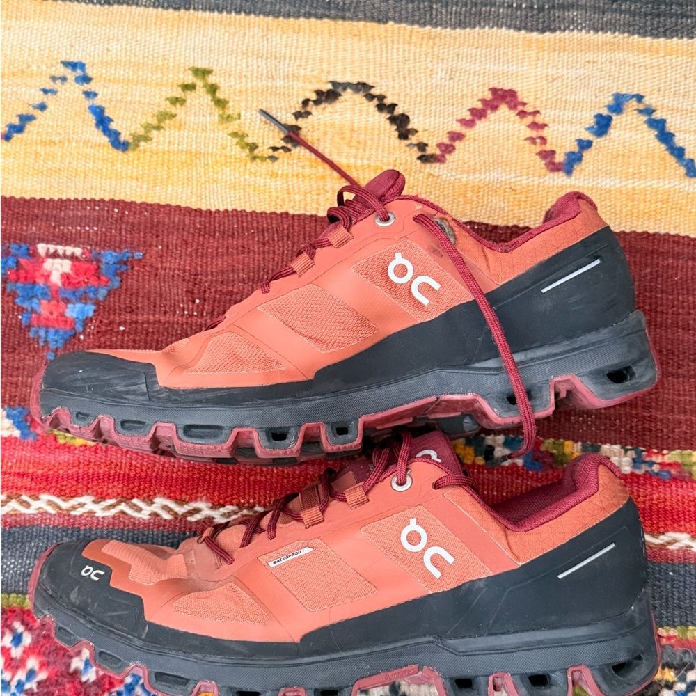 On Women’s Waterproof tracking Shoes in burgundy with Black Trim